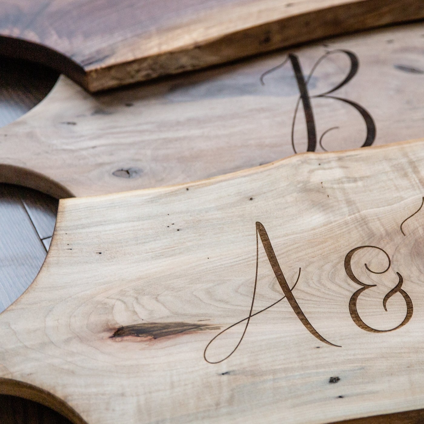 Close detail of engraved charcuterie board lettering and wood tone