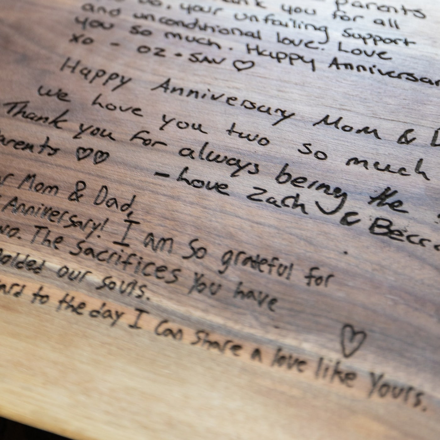 Handwritten messages engraved into a live edge board