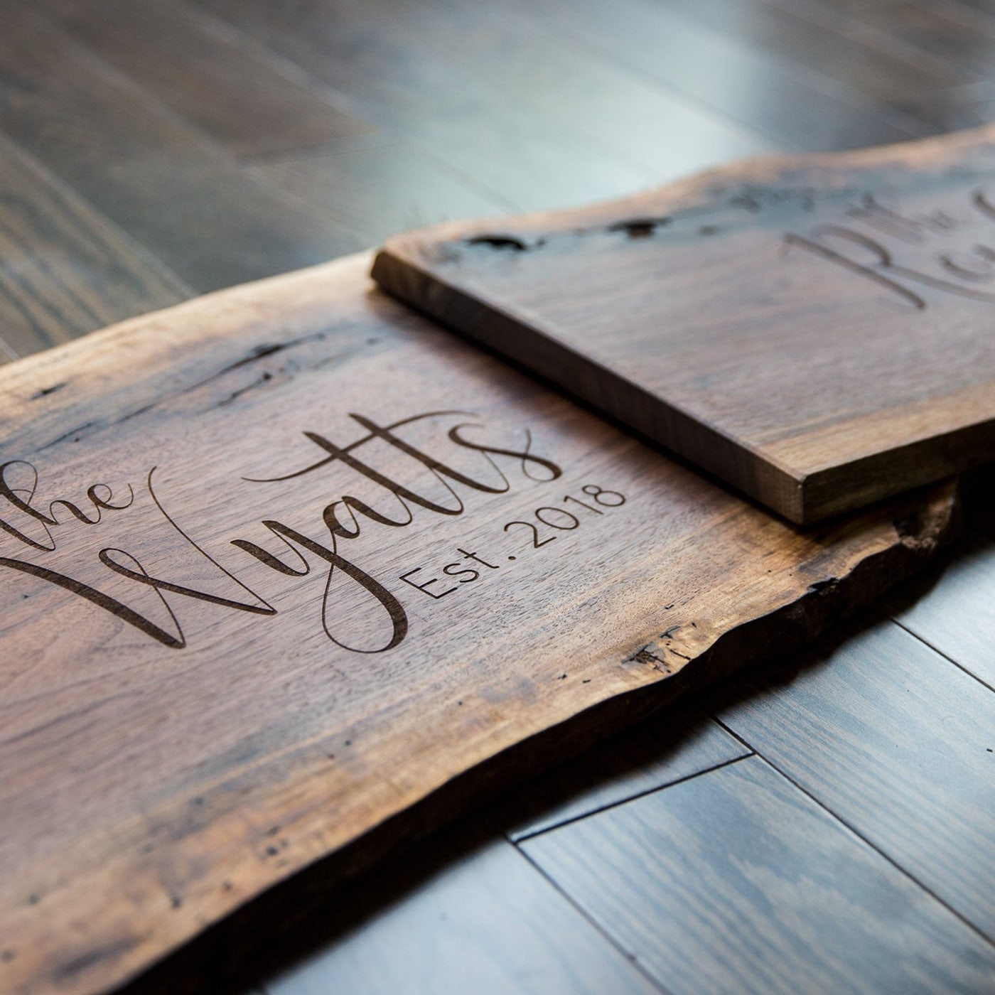 Close detail of engraved family name on a custom wood sign